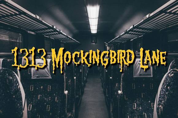 1313 Mockingbird Lane Font with slimy, spooky yellow text on a dark train interior background.