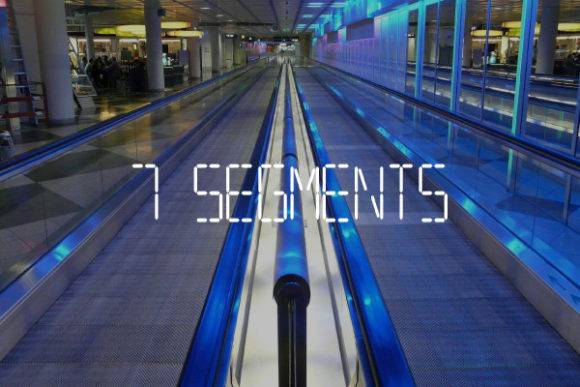 7Segments Font displayed on a futuristic moving walkway with blue lighting.