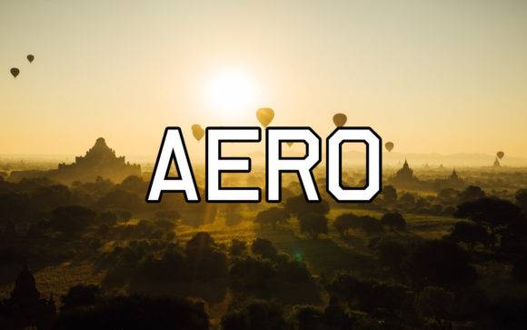 Aero Font - Geometric sans serif typeface displayed over a scenic sunrise with hot air balloons.