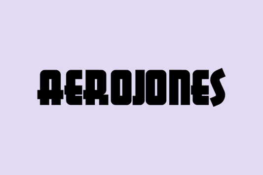 Aerojones Font bold blocky typeface on light purple background.