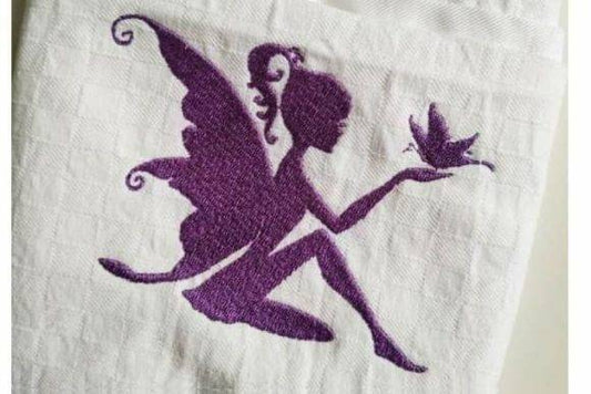 Purple fairy embroidery design holding a butterfly on white fabric.